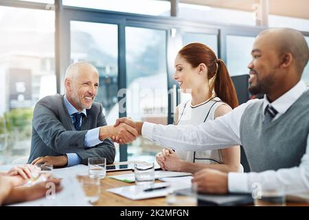 Welcome to the team. Cropped shot of two businessmen shaking hands during a meeting. Stock Photo