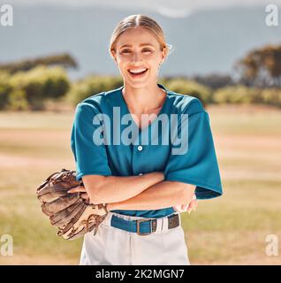 Woman, baseball and sports athlete on field in stadium for training, exercise and workout. Portrait, smile or happy professional player with glove Stock Photo