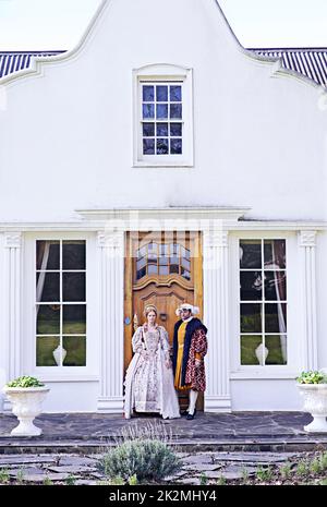 Abode of the nobility. a royal couple standing in front of their home. Stock Photo
