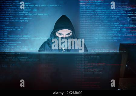 No system is safe from him. Shot of a young hacker using a computer late at night. Stock Photo
