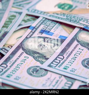 Cash hundred-dollar bills, banknotes are scattered dollar background image. Stock Photo