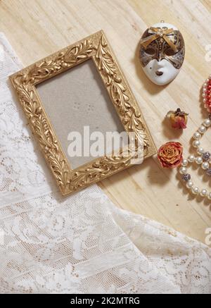 Gold Photo Frame on Wooden Background With Carnival Mask and Lace Stock Photo