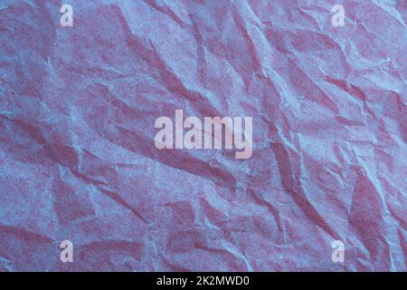 crumpled paper on a red surface Stock Photo