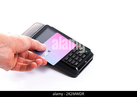 Attached plastic card to the payment terminal with a man's hand on a white isolated background, copy space Stock Photo