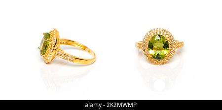 Peridot and Diamond Jewel or gems ring on white background with reflection. Collection of natural gemstones accessories. Studio shot Stock Photo