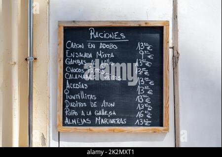 A menu for tapas or raciones on a blackboard outside a restaurant or cafe in Spain Stock Photo