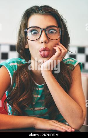 So what, Im having fun. Shot of a beautiful young woman in a diner. Stock Photo