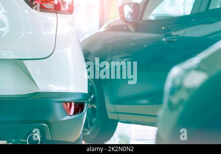 Rearview car parked in luxury showroom. Car dealership office. New car parked in modern showroom. Car for sale and rent business concept. Automobile leasing and insurance concept. Automobile market. Stock Photo