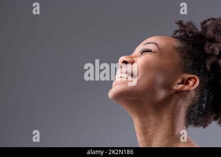 Happy vivacious laughing young African woman Stock Photo