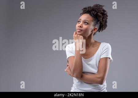 Pretty thoughtful young African woman Stock Photo
