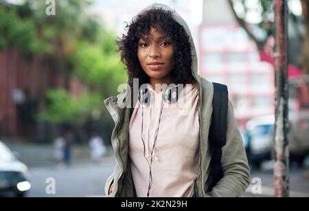 portrait african american woman in city street wearing headphones Stock Photo