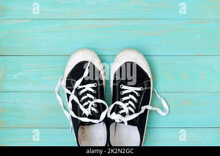 Sneakers on an old blue wooden surface Stock Photo