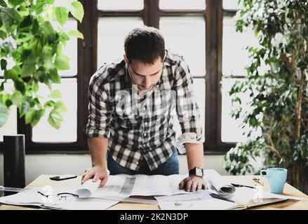 Man working on architectural project Stock Photo