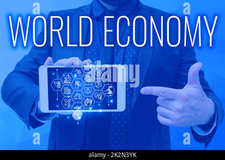 Text sign showing World Economy. Internet Concept Global Worldwide International markets trade money exchange Man holding Screen Of Mobile Phone Showing The Futuristic Technology. Stock Photo