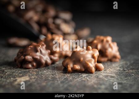 Chocolate truffles. Sweet pralines on black table. Stock Photo