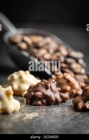 Chocolate truffles. Sweet pralines on black table. Stock Photo