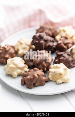 Chocolate truffles. Sweet pralines on plate. Stock Photo