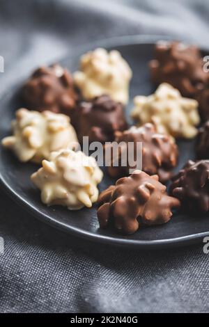Chocolate truffles. Sweet pralines on plate. Stock Photo