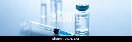 Medical syringe with a needle and a bollte with vaccine. Stock Photo