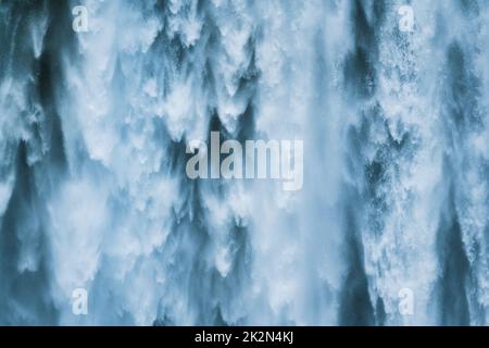 Close up powerful large natural waterfall flowing from cliff in summer Stock Photo