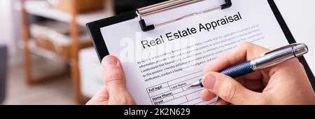 Man Filling Real Estate Appraisal Form Stock Photo