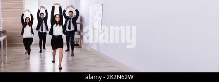 Businesspeople Doing Stretching Exercise Stock Photo