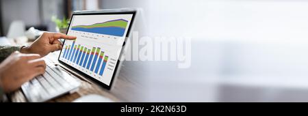 Businessman Analyzing Graph On Laptop Stock Photo