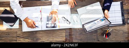 Businesspeople Using Laptop In Office Stock Photo