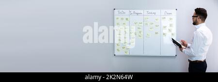 Businessman Writing On Sticky Notes Stock Photo