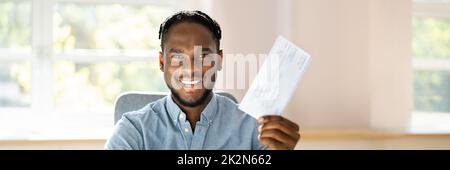 Holding Paycheck Or Payroll Check Or Insurance Cheque Stock Photo