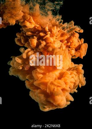 orange acrylic ink in water Stock Photo