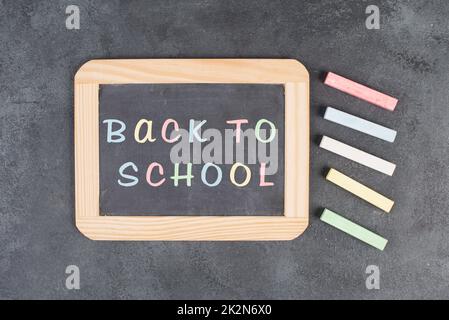 Chalkboard with the text back to school, education concept, colorful chalk Stock Photo