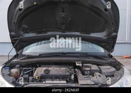 Car under opened hood. Used car Stock Photo