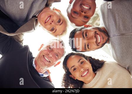 Our diversity is what allows us to excel. Portrait of a group of businesspeople standing together in a huddle. Stock Photo
