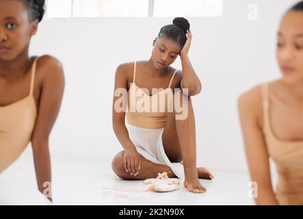 I am scarred, but not disfigured. Studio shot of a young ballet dancer having a stressful day in a dance studio. Stock Photo