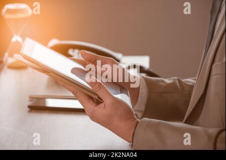 Businessman using digital tablet PC at workplace. Business apps concept, close up view. Stock Photo