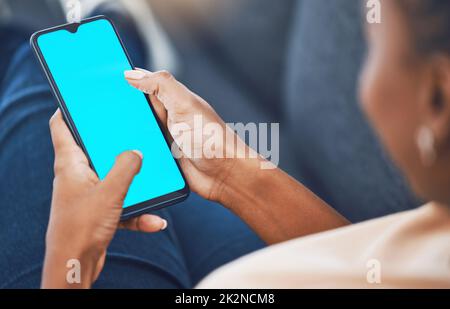 Black woman, hands and phone with green screen mockup for marketing, branding and advertising. African female hand on mobile technology with blank Stock Photo