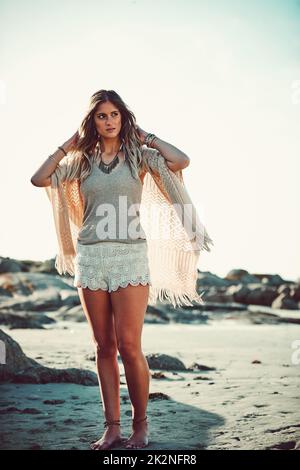 Where being free is all that matters. Shot of an attractive young woman spending a day at the beach. Stock Photo