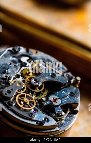 Close up on a disassembled watch or clock mechanism with gear wheels Stock Photo