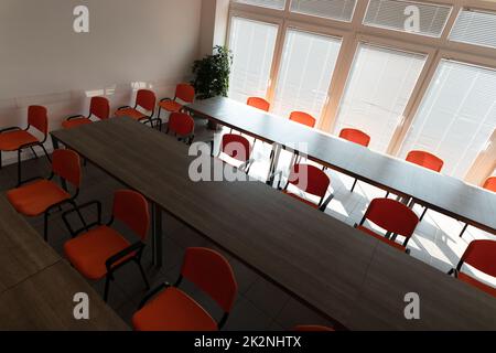 Empty desks and chairs in office conference room Stock Photo