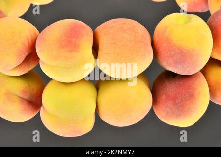 Ripe peaches isolated on mirror background. High resolution photo. Full depth of field. Stock Photo