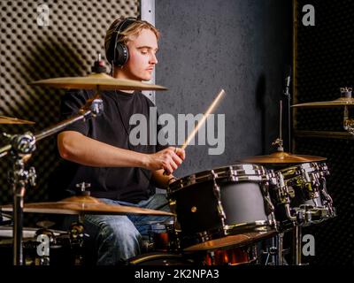Young man playing drums in a recording studio Stock Photo