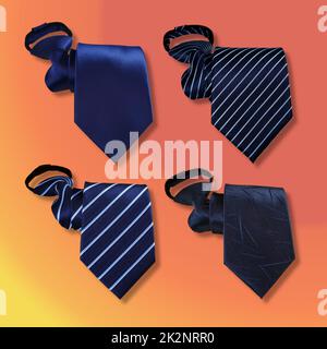 A set of plain and stiped navy blue male neckties on orange background Stock Photo
