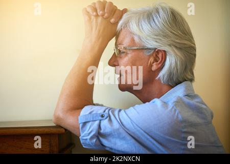 Leave your hopes with the Higher Power. Cropped shot of a senior woman with her hands clasped in prayer. Stock Photo