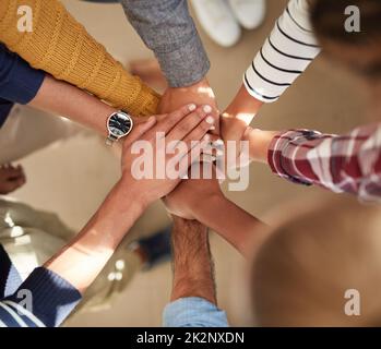Their determination is strong. High angle shot of a group of people joining their hands together. Stock Photo