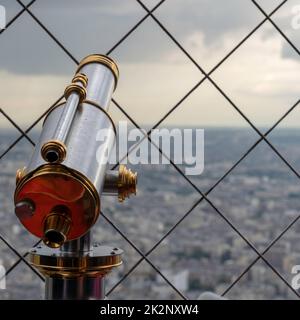 A closeup shot of a telescope looking out over the skyline of Paris, France Stock Photo