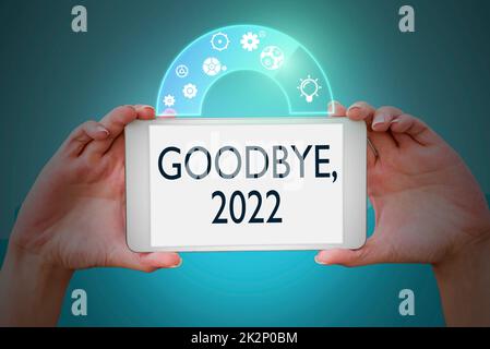 Text showing inspiration Goodbye 2022. Concept meaning New Year Eve Milestone Last Month Celebration Transition Hands holding tablet presenting innovative ideas symbolizing technology. Stock Photo