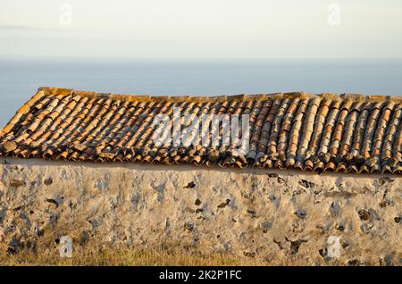 Roof and wall of an abandoned house. Stock Photo