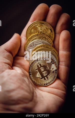 Silver and gold various digital cryptocurrency coins, with Bitcoin on top Stock Photo
