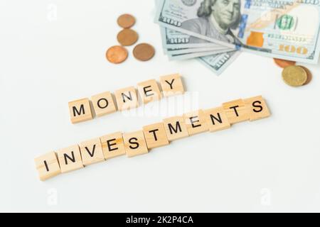 International currency money including euro, dollar, coin, dollar bill. The inscription in wooden letters money investments. The concept of investments, loans, debts. Stock Photo